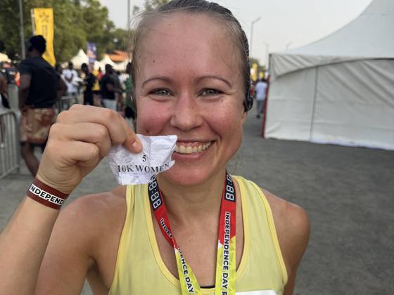 A runner with her fifth-place slip for the 10K women